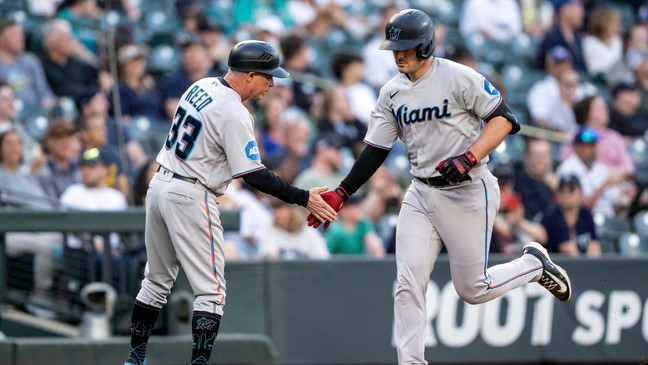 Miami Marlins' Nick Fortes, right, is congratulated by third base coach Jody Reed after hitting a solo home run off Seattle Mariners starting pitcher Bryce Miller during the fifth inning of a baseball game, Monday, June 12, 2023, in Seattle. (AP Photo/Stephen Brashear)
