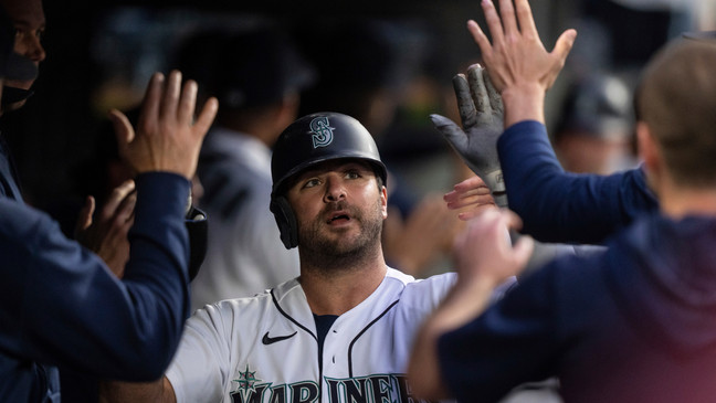 Seattle Mariners' Mike Ford is celebrates in the dugout after scoring on a three-run triple by Jose Caballero during the sixth inning of the team's baseball game against the Miami Marlins, Tuesday, June 13, 2023, in Seattle. (AP Photo/Stephen Brashear)
