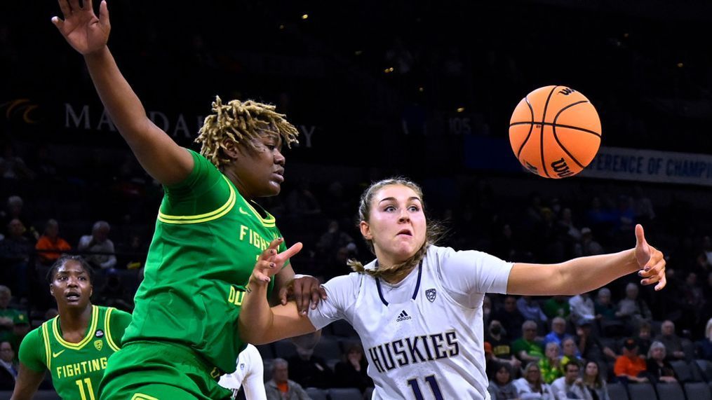 Oregon center Phillipina Kyei, left, and Washington forward Haley Van Dyke (11) vie for the ball during the second half of an NCAA college basketball game in the first round of the Pac-12 women's tournament Wednesday, March 1, 2023, in Las Vegas. (AP Photo/David Becker)